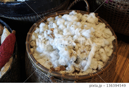 Raw cotton in bamboo basket. Material before process for fibre textile Raw cotton in bamboo basket. Material before process for fibre textile 136394549