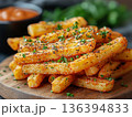 Premium seasoned French fries or potato chips with herbs served on wooden board. Gourmet street food. Upscale fast-food menu, takeaway branding, delivery platform and casual dining advertising. 136394833