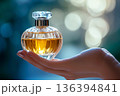 Luxury perfume bottle held in female hand with soft bokeh background. Premium beauty, fragrance storytelling concept. Lifestyle branding, fashion concepts, cosmetic and emotional luxury visuals. 136394841