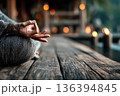 Person practicing meditation. Meditative yoga practice on wooden floor. Mindfulness, relaxation, spiritual balance, wellness lifestyle, stress relief, inner harmony. Faceless scene with copy space. 136394845