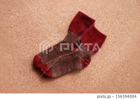 コルク背景に平置きした赤と茶色の靴下 秋冬の冷え対策をイメージした生活用品素材 コルク背景に平置きした赤と茶色の靴下 秋冬の冷え対策をイメージした生活用品素材 136394884