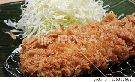 Pork cutlet and shredded cabbage on a plate 136395663