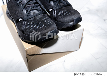 Performance running sneakers presented with simple shoe box. Performance running sneakers presented with simple shoe box. 136396679