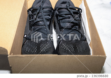 Performance running sneakers presented with simple shoe box. 136396680