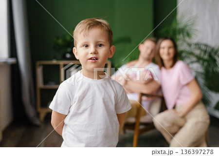 Little Boy Standing With Parents And Baby Behind Little Boy Standing With Parents And Baby Behind 136397278