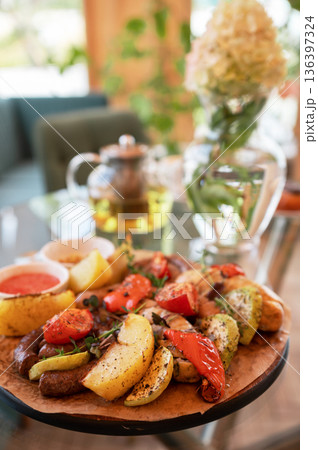Grilled Sausages with Vegetables and Dipping Sauces 136397324