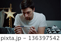 A portrait of a man in deep despair clutching a pregnancy test. The image captures a moment of intense emotional breakdown and mental exhaustion regarding family news 136397542