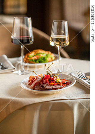 Italian antipasti platter with meat and wine 136397810