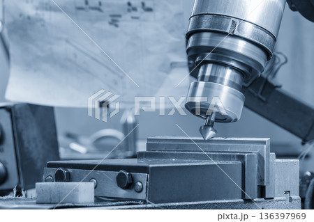 Chamfer Processing of Metal Plate Parts on NC Milling Machine in Blue Tone Scene Chamfer Processing of Metal Plate Parts on NC Milling Machine in Blue Tone Scene 136397969