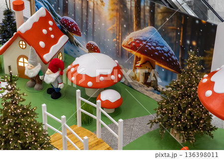 Festive Christmas display showcasing cheerful gnomes, whimsical mushroom houses, and sparkling trees, creating a magical winter wonderland scene for holiday joy 136398011