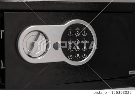 Modern black electronic safe displaying a digital keypad with visible READY, LOW BATTERY, PROCEED indicators, offering secure storage and robust asset protection for valuables 136398029