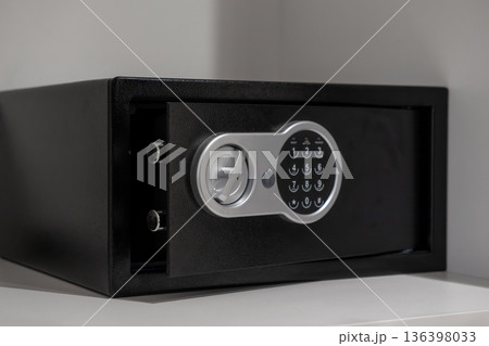 Sleek black digital safe with an open door and visible locking bolts, emphasizing robust security for valuables in modern hotel rooms or secure home storage Sleek black digital safe with an open door and visible locking bolts, emphasizing robust security for valuables in modern hotel rooms or secure home storage 136398033