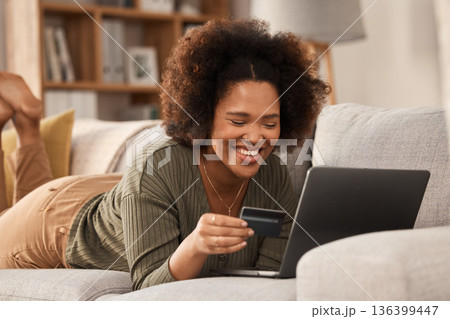 Black woman, credit card and laptop on sofa for online shopping, digital payment and fintech account. Happy female person, computer banking and money for sales, password and ecommerce finance at home Black woman, credit card and laptop on sofa for online shopping, digital payment and fintech account. Happy female person, computer banking and money for sales, password and ecommerce finance at home 136399447