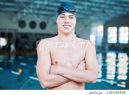 Swimming, sports and portrait of man by pool for training, competition and exercise in gym. Professional, fitness and male swimmer with crossed arms for challenge, workout and practice for wellness Swimming, sports and portrait of man by pool for training, competition and exercise in gym. Professional, fitness and male swimmer with crossed arms for challenge, workout and practice for wellness 136399489