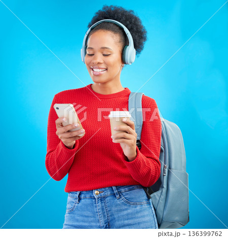 Phone music, student or happy woman reading education article, online university post and listening to radio podcast. Audio headphones, cellphone or college person on coffee break on blue background Phone music, student or happy woman reading education article, online university post and listening to radio podcast. Audio headphones, cellphone or college person on coffee break on blue background 136399762
