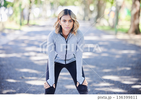 Fitness, exercise and portrait of a woman outdoor at a park with commitment and focus on wellness. Young female person on a road in nature for a break or rest after workout, running or training Fitness, exercise and portrait of a woman outdoor at a park with commitment and focus on wellness. Young female person on a road in nature for a break or rest after workout, running or training 136399811