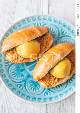 Vada Pav Indian street food served on blue plate in bright overhead composition Vada Pav Indian street food served on blue plate in bright overhead composition 136399853