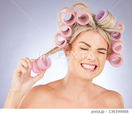 Woman, hair care and pain with roller for beauty in studio isolated on a white background. Happy, curlers and model with hairstyle for aesthetic, cosmetics and salon treatment for natural growth. 136399866