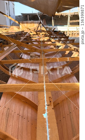 Planking Finishing Inside Hull With Bright Light And Clean Seams, Finisher Smoothing Joints And Applying Sealant, Close View Of Grain And Tools, Calm Professional Finishing Mood 136399871