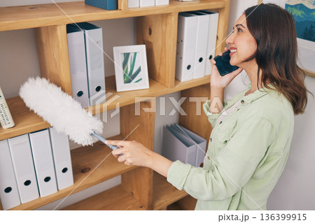 Cleaning, phone call and dust with woman in office for housekeeping service, communication and sanitary. Contact, networking and conversation with female cleaner and bookshelf for chat and hygiene Cleaning, phone call and dust with woman in office for housekeeping service, communication and sanitary. Contact, networking and conversation with female cleaner and bookshelf for chat and hygiene 136399915