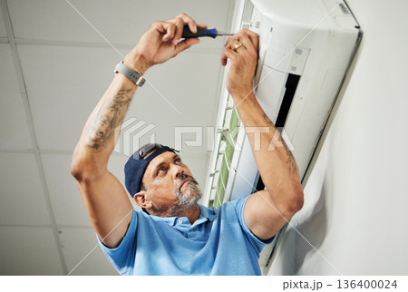 Electrician, inspection and air conditioning with man and screwdriver for maintenance, ventilation and power. Engineering, electricity and ac repair with technician and tools for fan and contractor Electrician, inspection and air conditioning with man and screwdriver for maintenance, ventilation and power. Engineering, electricity and ac repair with technician and tools for fan and contractor 136400024