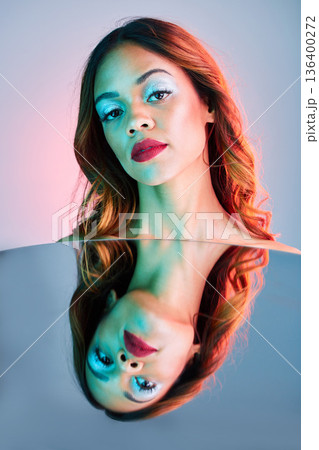 Art, mirror and beauty, portrait of woman on studio background with neon light and makeup. Fashion, skin and future aesthetic, face of girl or model in creative reflection with cosmetics and color. Art, mirror and beauty, portrait of woman on studio background with neon light and makeup. Fashion, skin and future aesthetic, face of girl or model in creative reflection with cosmetics and color. 136400272