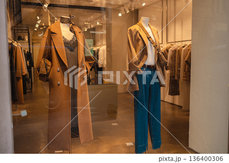 Fashionable autumn clothing display in a boutique window 136400306