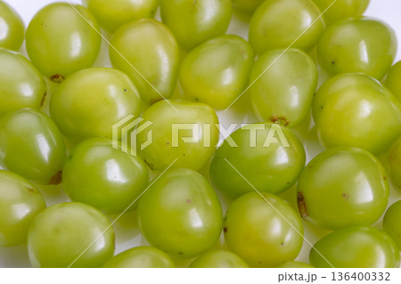 Grapes closeup imagery, Vivid green fruit macro shot, Detailed image of translucent grape spheres, Photograph showcasing lush green grapes with refined aesthetic style 136400332