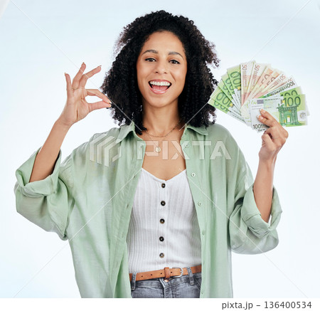 Woman, ok sign and money in studio portrait for prize, profit or win with investing, savings or notes by white background. Isolated African girl, excited student and cash with icon, gambling or lotto 136400534
