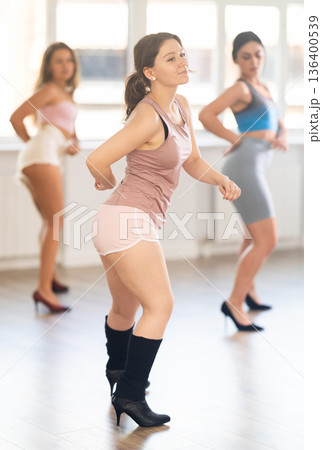 Young female dancer in heels practicing jazz-funk in studio 136400539