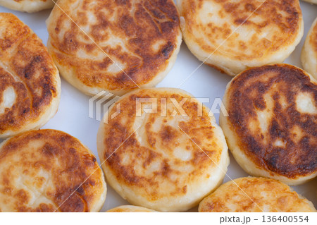 Market syrniki arranged as street snack, vivid golden tones and fried texture suggesting vendor stall offering and quick grabandgo appeal for food tourism and travel content Market syrniki arranged as street snack, vivid golden tones and fried texture suggesting vendor stall offering and quick grabandgo appeal for food tourism and travel content 136400554