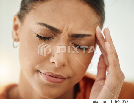 Face, woman and pain of headache from stress, mental health and sick of fatigue. Closeup of sad female person with depression, anxiety or frustrated with brain fog, debt and crisis of burnout 136400583