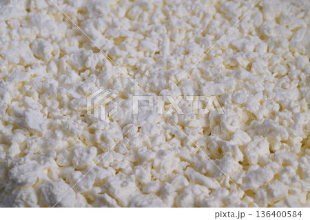 Creamy cheese closeup, Bright white curd detail, Natural light highlights soft cheddar surface, Rustic dairy product showcasing textured curd with natural shine Creamy cheese closeup, Bright white curd detail, Natural light highlights soft cheddar surface, Rustic dairy product showcasing textured curd with natural shine 136400584