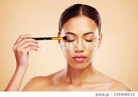 Makeup, brush and woman with cosmetic beauty product application for skincare isolated in a studio brown background. Eyelid, elegant and powder for cosmetology aesthetic, glow and soft skin glamour Makeup, brush and woman with cosmetic beauty product application for skincare isolated in a studio brown background. Eyelid, elegant and powder for cosmetology aesthetic, glow and soft skin glamour 136400618