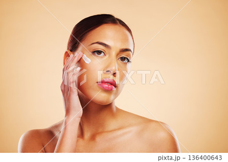 Skincare, portrait or woman with face cream or sunscreen product in grooming routine with cosmetics. Dermatology, studio background or beauty model applying natural facial creme lotion moisturizer Skincare, portrait or woman with face cream or sunscreen product in grooming routine with cosmetics. Dermatology, studio background or beauty model applying natural facial creme lotion moisturizer 136400643