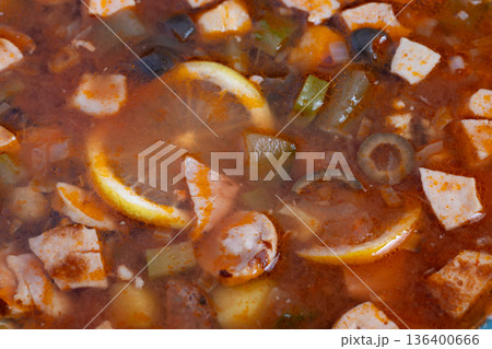Nourishing wholesome bowl filled with vivid flavors and rustic elements, Reassuring and substantial stew presented in rural bowl with zestful lemon and smoked sausages Nourishing wholesome bowl filled with vivid flavors and rustic elements, Reassuring and substantial stew presented in rural bowl with zestful lemon and smoked sausages 136400666