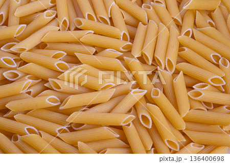 Detailed view of artisanal pasta with textured semolina surface, Highresolution image showcasing tightly packed raw pasta tubes with rough semolina coating for design use Detailed view of artisanal pasta with textured semolina surface, Highresolution image showcasing tightly packed raw pasta tubes with rough semolina coating for design use 136400698