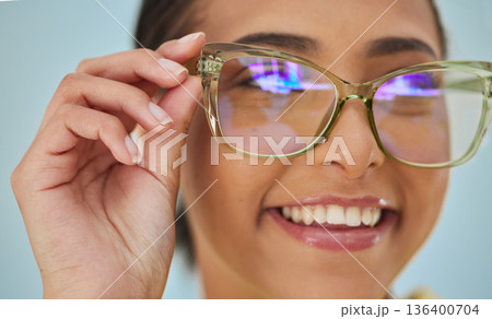 Woman, glasses and vision with blue light frame with a smile with ophthalmology. Isolated, studio background and happy person with eye care, wellness and health of a girl with eyewear and healthcare Woman, glasses and vision with blue light frame with a smile with ophthalmology. Isolated, studio background and happy person with eye care, wellness and health of a girl with eyewear and healthcare 136400704