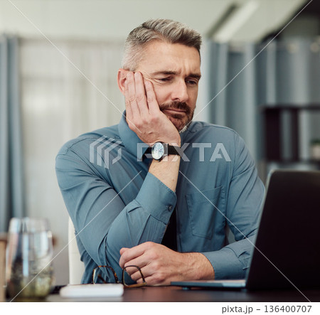 Confused, bored and business man at laptop in office with stress, fatigue and problem. Computer, tired and mature manager with doubt, financial crisis and reading debt email, tax audit and burnout 136400707