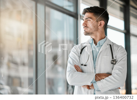 Doctor, thinking and arms crossed at the window in hospital, clinic and vision for the future of healthcare, medicine or surgery. Man, medical worker or intern with decision, choice and ideas Doctor, thinking and arms crossed at the window in hospital, clinic and vision for the future of healthcare, medicine or surgery. Man, medical worker or intern with decision, choice and ideas 136400732