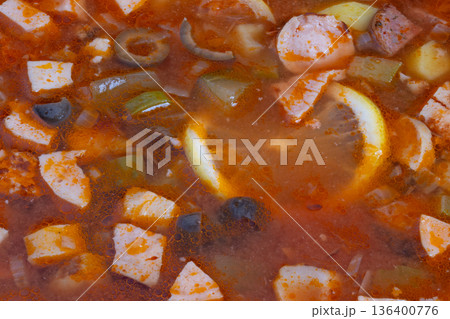 Detailed food presentation, Highresolution image highlighting intricate textures and garnishes, Appetizing closeup of flavorful solyanka with fresh lemon and aromatic herbs 136400776