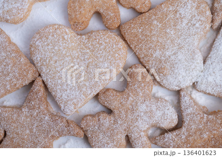 Artisan bakery style heart cookie highlighted by natural daylight, Textured heartshaped biscuit decorated with powdered sugar and illuminated by soft natural lighting Artisan bakery style heart cookie highlighted by natural daylight, Textured heartshaped biscuit decorated with powdered sugar and illuminated by soft natural lighting 136401623