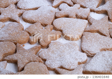 Close crop holiday cookies dusted powdered sugar, variety of cutout shapes, warm golden crusts, subtle festive mood, tabletop setting, ready for gifting or serving Close crop holiday cookies dusted powdered sugar, variety of cutout shapes, warm golden crusts, subtle festive mood, tabletop setting, ready for gifting or serving 136401640