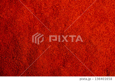 Market paprika heat and aroma captured in glowing emberlike red powder, suggesting nourishing healthy plantbased flavor for vegan cooking and spice market displays 136401658