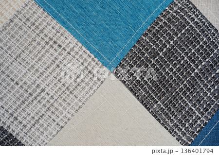 Close up textured fabric upholstery samples in blue beige gray 136401794