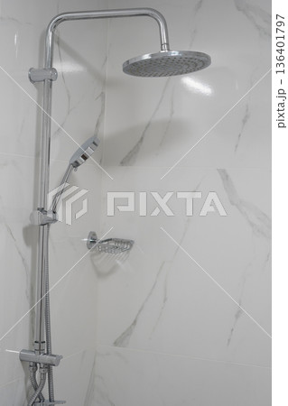 Modern chrome shower system in bright marble bathroom interior design 136401797