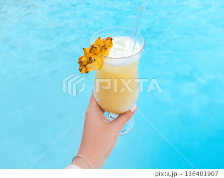 Woman's hand holds a refreshing cocktail Woman's hand holds a refreshing cocktail 136401907