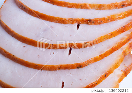 Detailed image of roasted meat. Highresolution photograph showing overlapping roasted meat slices. Closeup detailed image capturing textures of sliced seasoned roasted meat 136402212