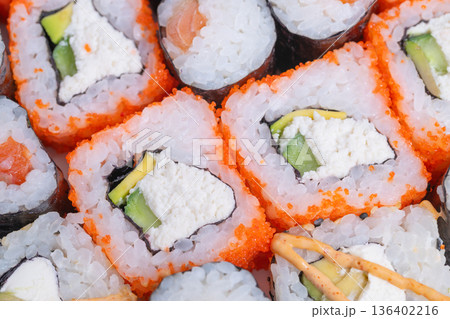 Eventfriendly sushi options with diverse rolls and lively toppings. Elegant selection of fingersized sushi pieces with colorful toppings for special celebrations Eventfriendly sushi options with diverse rolls and lively toppings. Elegant selection of fingersized sushi pieces with colorful toppings for special celebrations 136402216