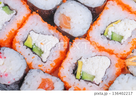 Artful sushi presentation. Exquisite sushi with layered fillings and sharp cuts. Sushi assortment demonstrating craftsmanship through precise cuts and strategic layering Artful sushi presentation. Exquisite sushi with layered fillings and sharp cuts. Sushi assortment demonstrating craftsmanship through precise cuts and strategic layering 136402217